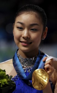 South Korea's Kim Yu-Na poses with the gold medal during the medals ceremony for the women's figure skating competition at the Vancouver 2010 Olympics in Vancouver, British Columbia, Thursday, Feb. 25, 2010. (AP Photo/Mark Baker)